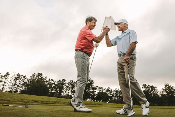 Two men playing golf