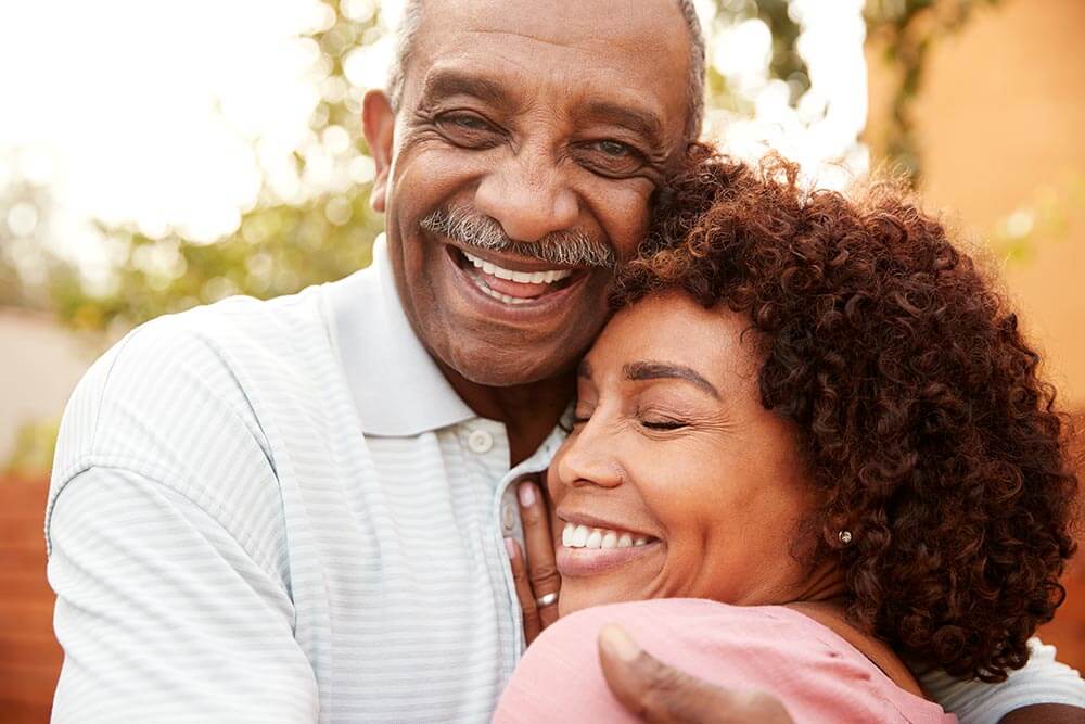 Man and woman embracing outside